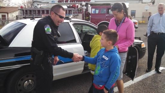 Officer shaking hand of child